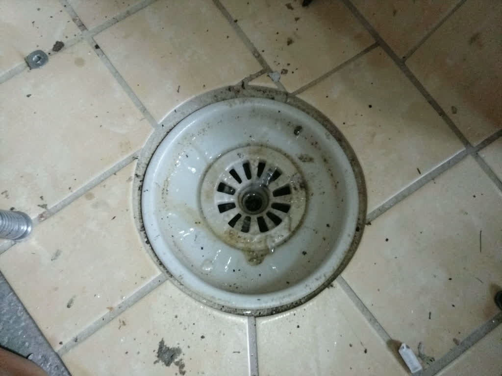 Clear water swirling into a chrome drain